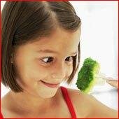 Girl eating broccoli on fork